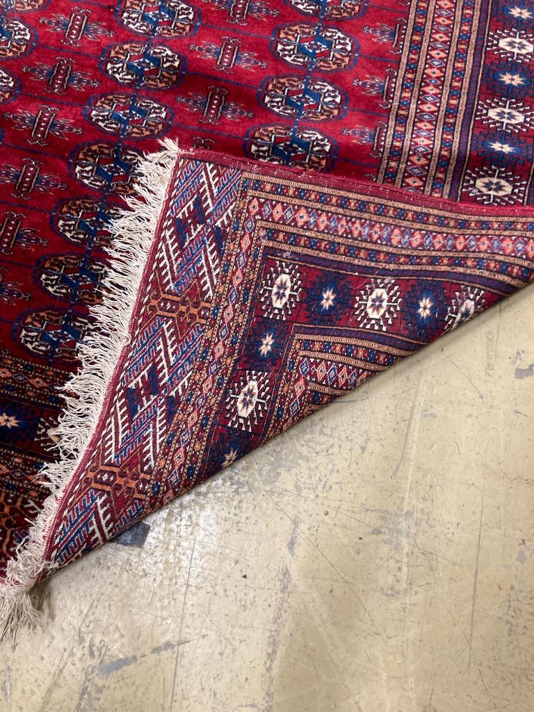 A Bokhara burgundy ground rug, 238 x 160cm